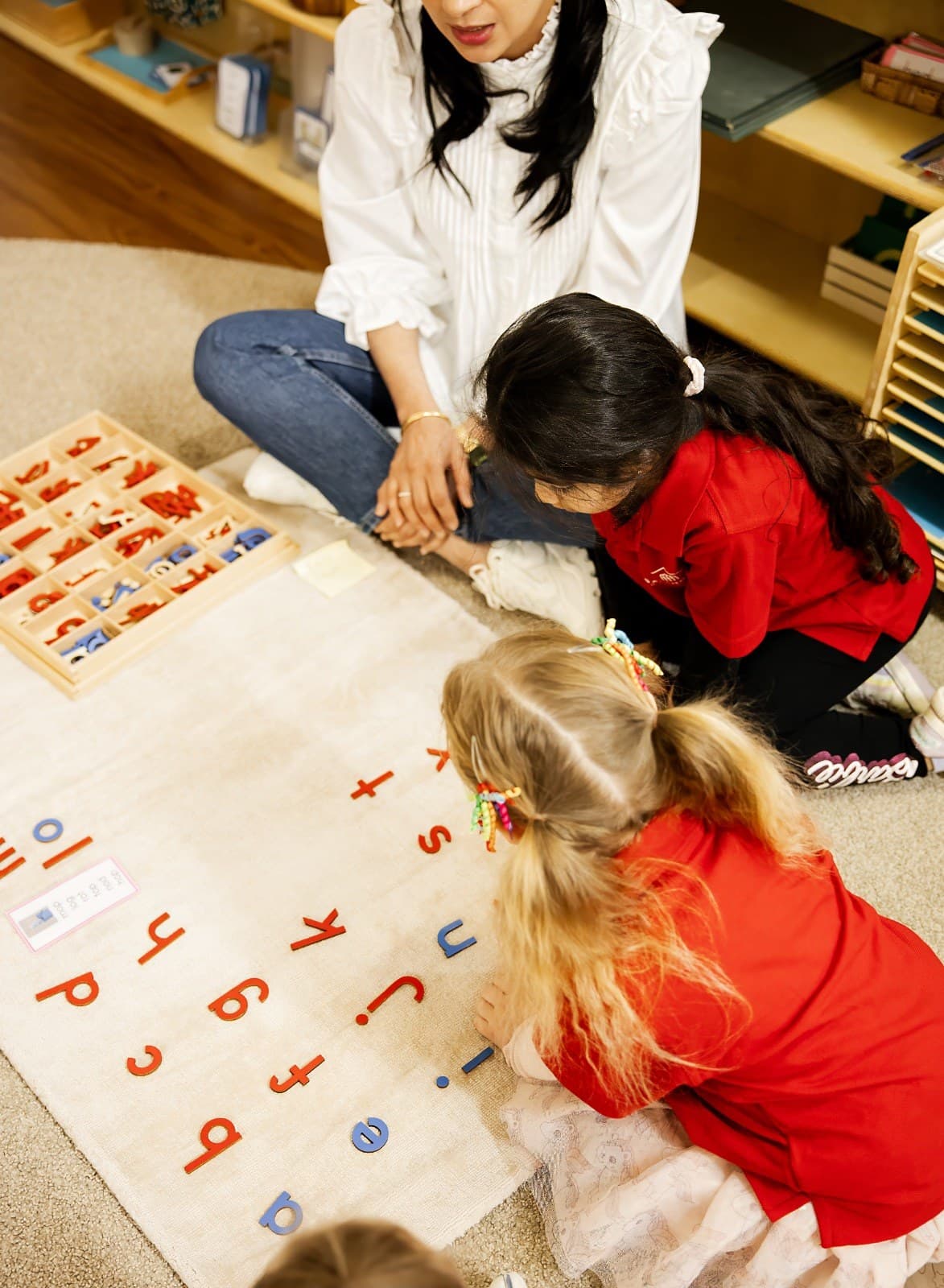 Children engaged in Montessori-style learning with an educator at Gatehouse Montessori Rosewater
